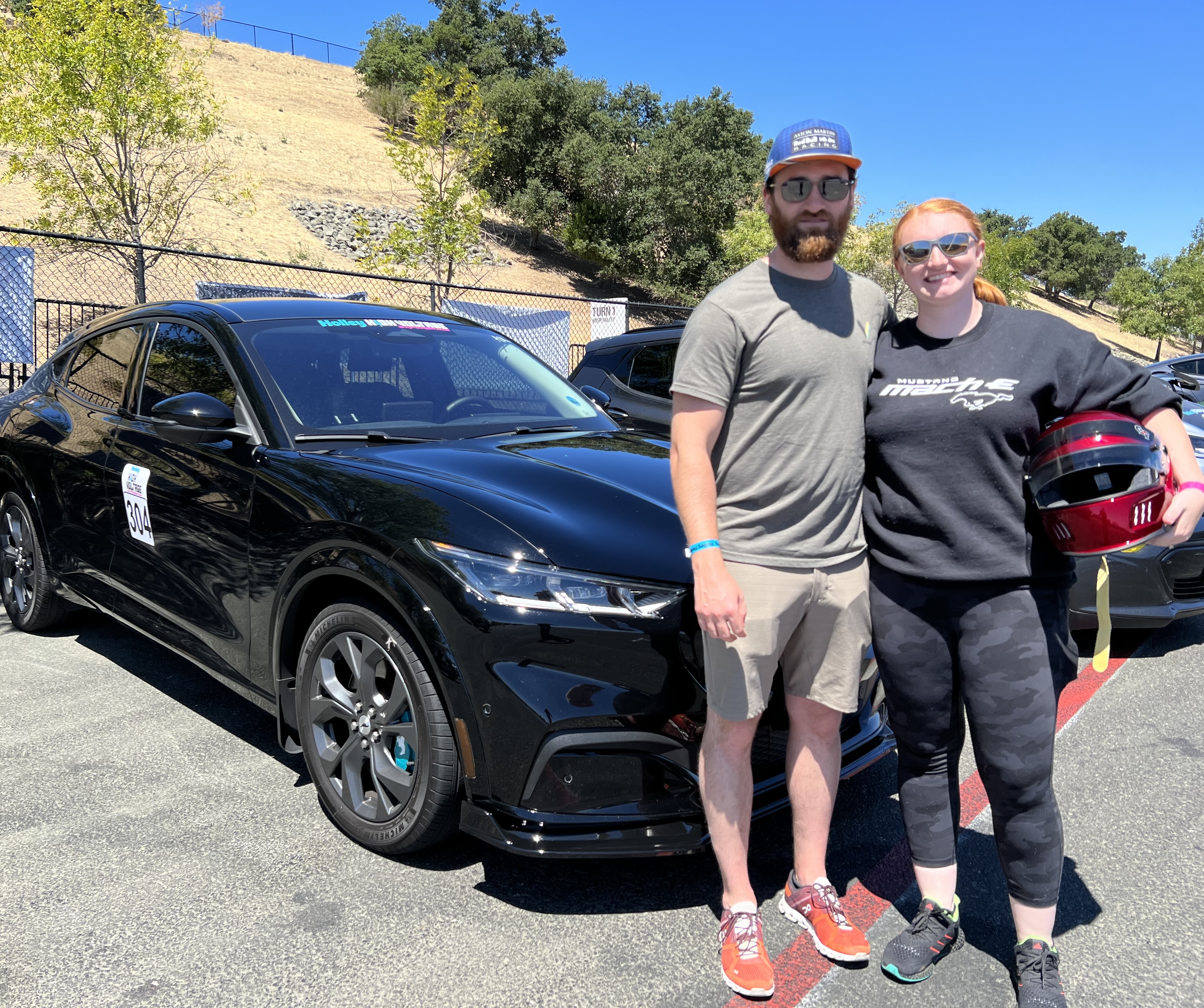 Sophie and her husband, Evan, with their 2021 Mustang Mach-E.